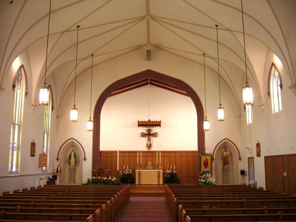 The inside of a church with a cross on the wall