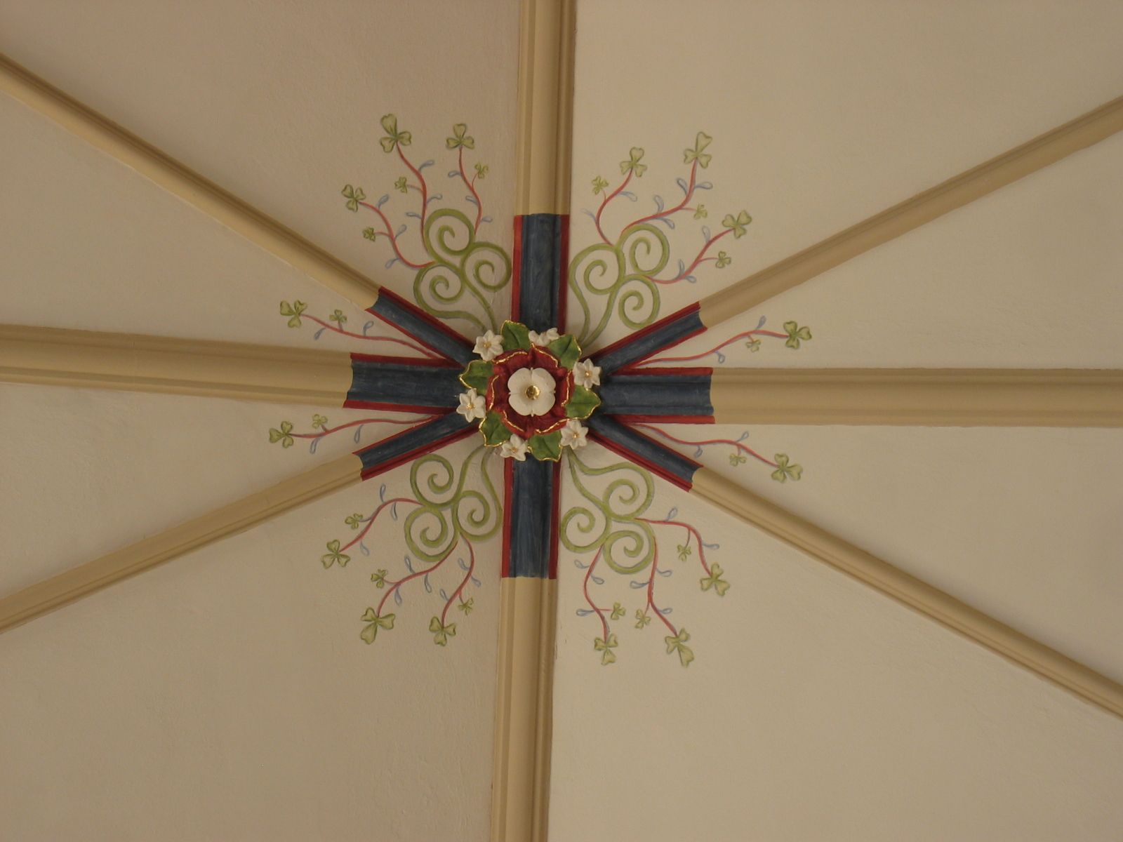 A ceiling with a floral design painted on it