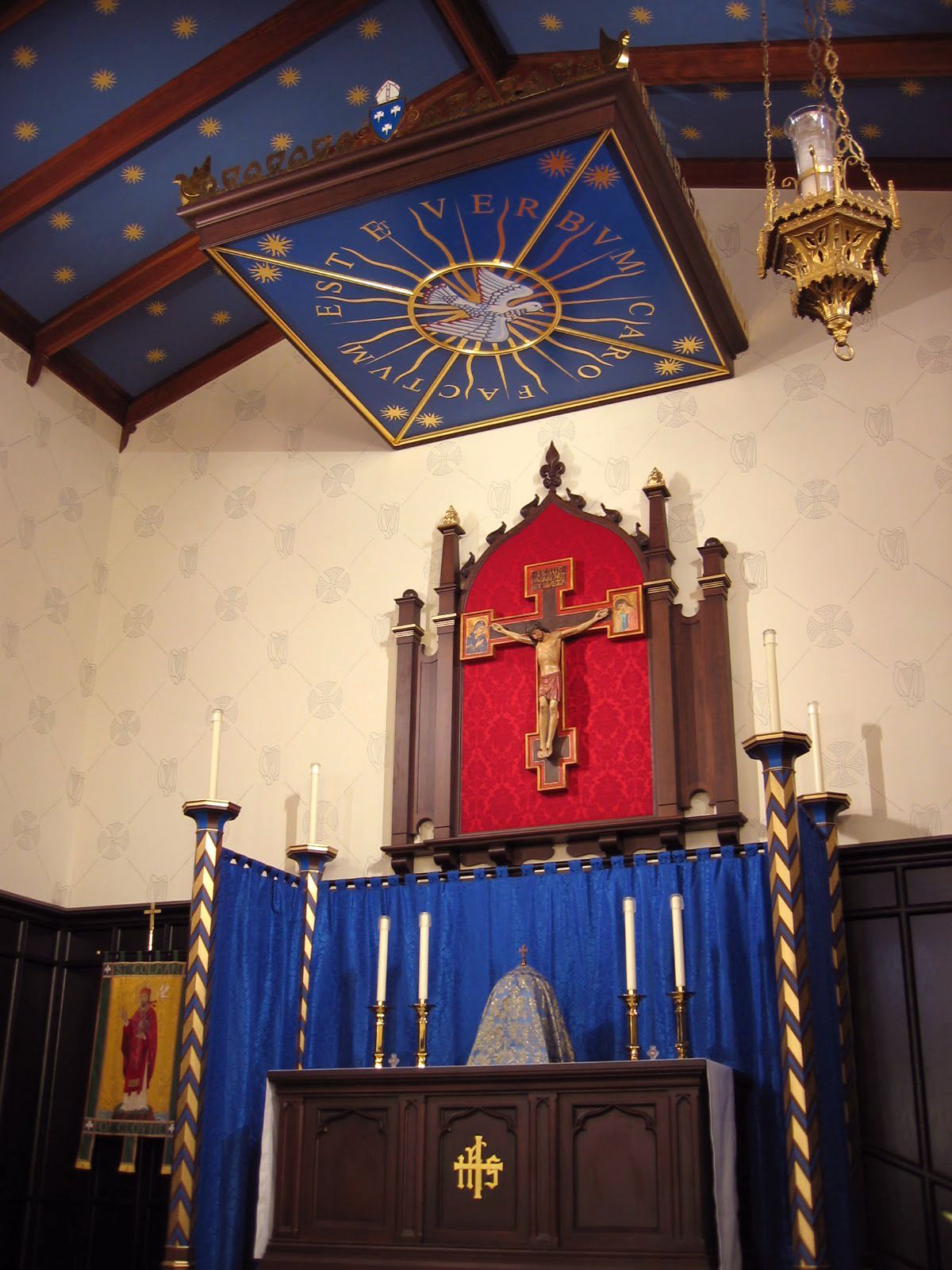 A church with a blue curtain and a cross on the wall