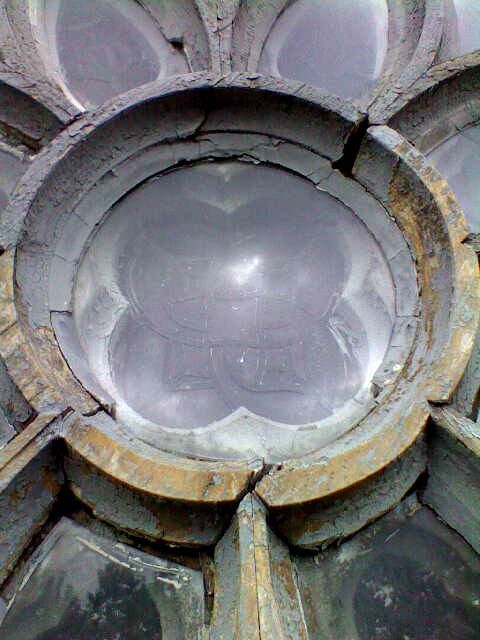 A close up of a stained glass window on a building.