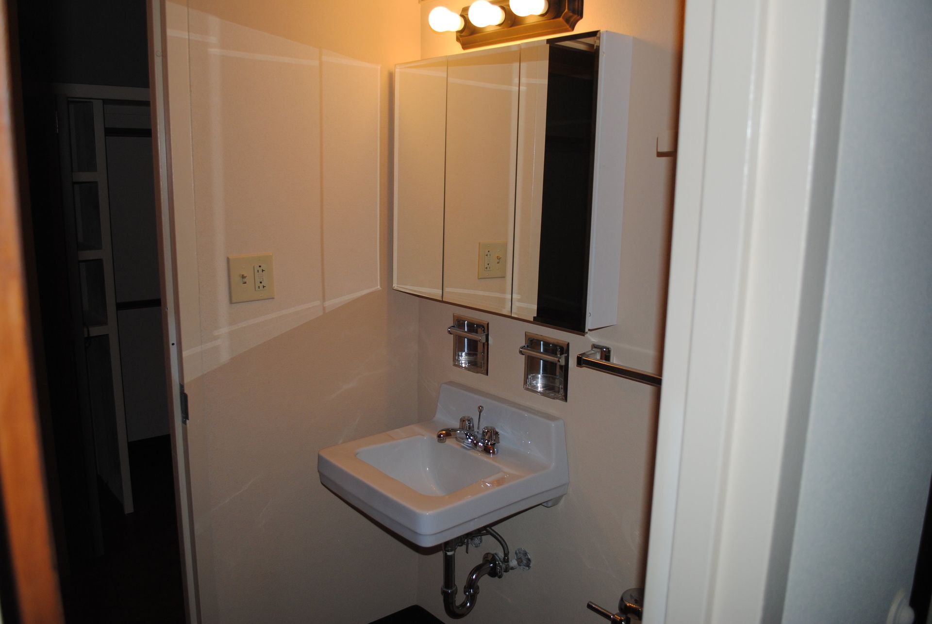A bathroom with a sink and a mirror