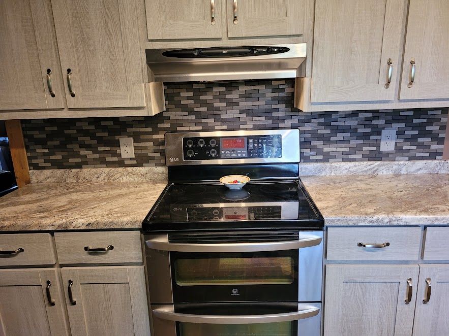 A kitchen with stainless steel appliances and granite counter tops.