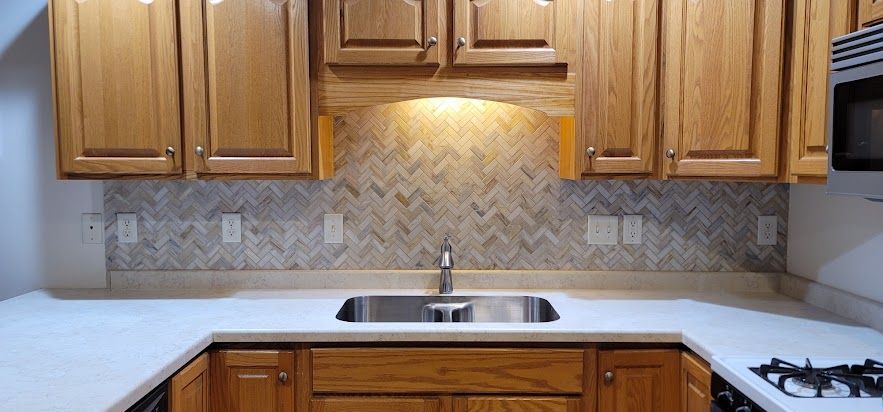 A kitchen with wooden cabinets and a stainless steel sink.
