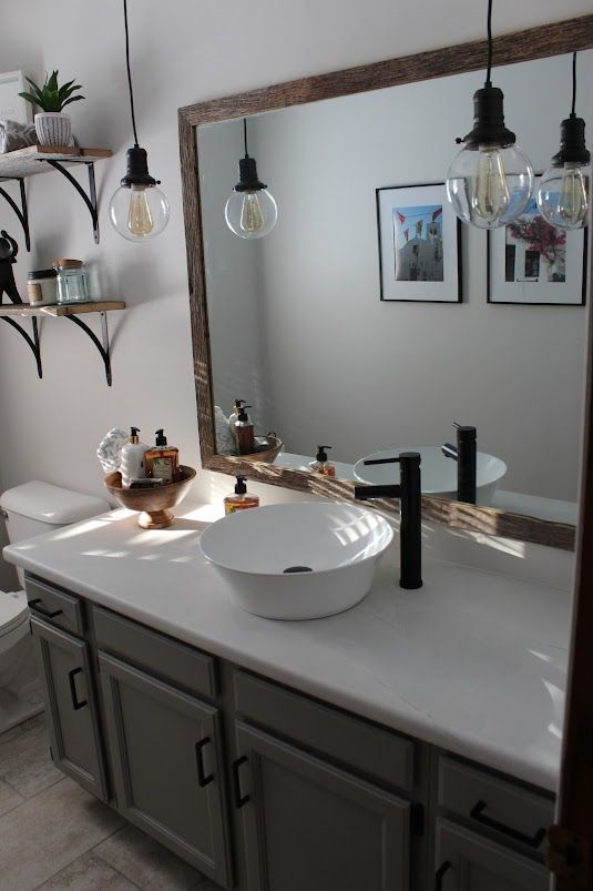 A bathroom with two sinks and a large mirror.