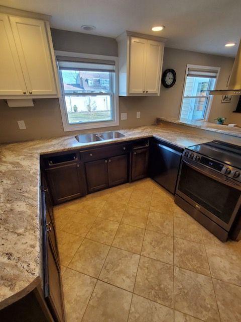 A kitchen with stainless steel appliances and granite counter tops
