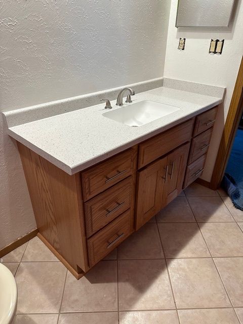 A bathroom vanity with a sink and a mirror