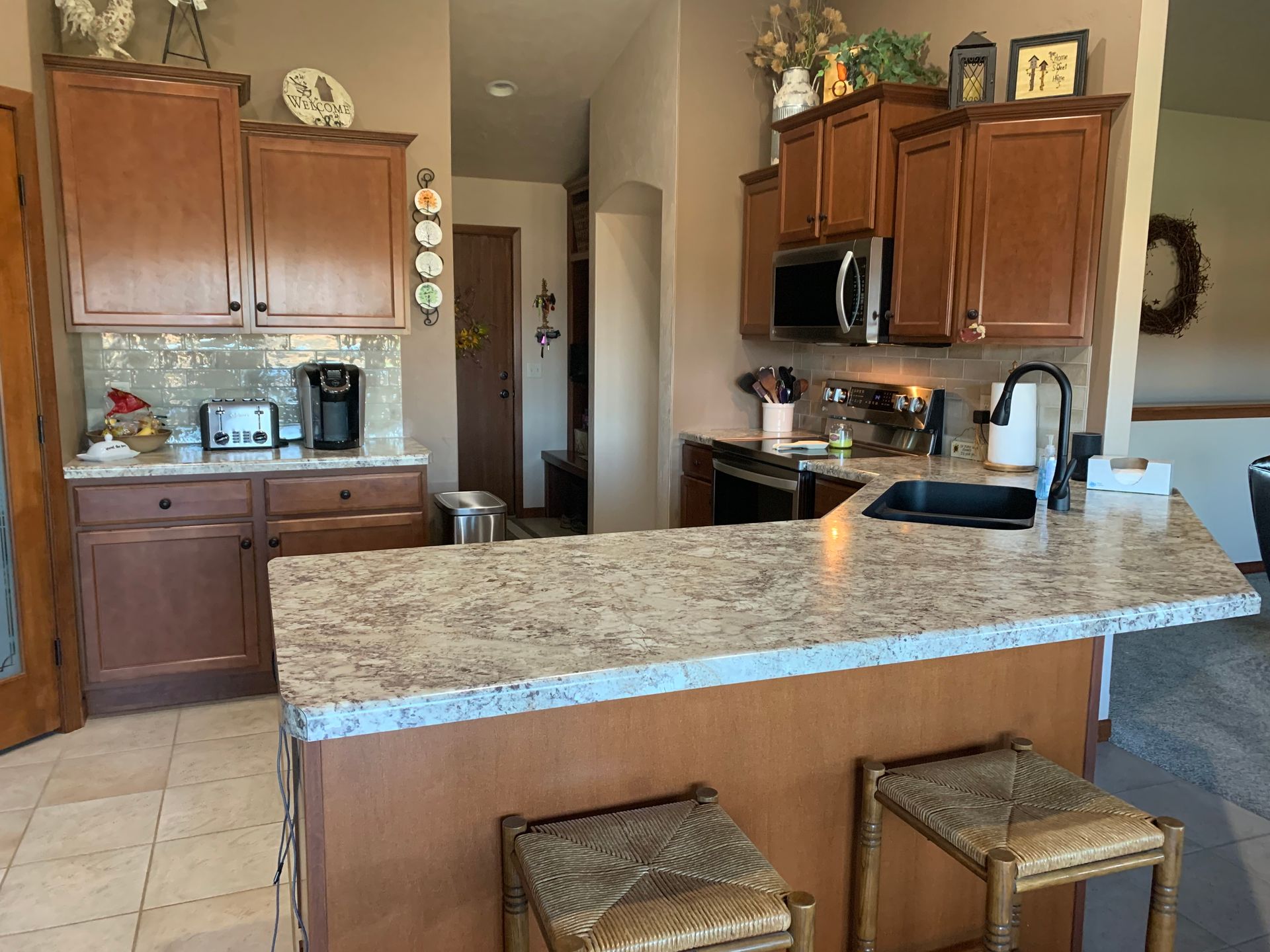 A kitchen with granite counter tops and wooden cabinets