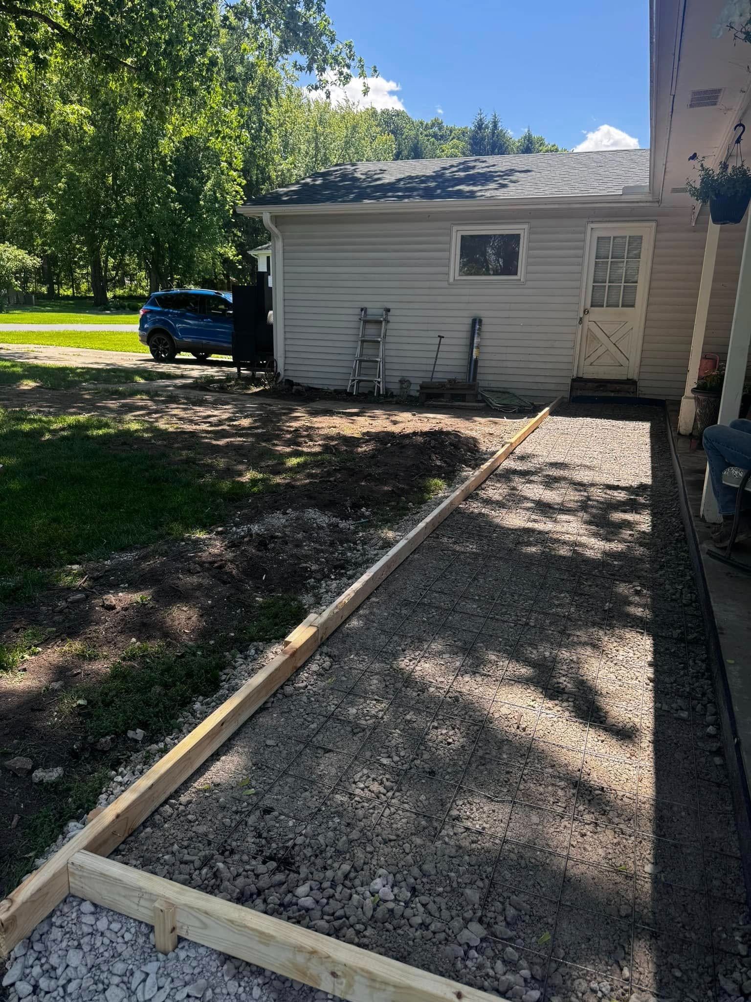 A white house with a blue truck parked in front of it.