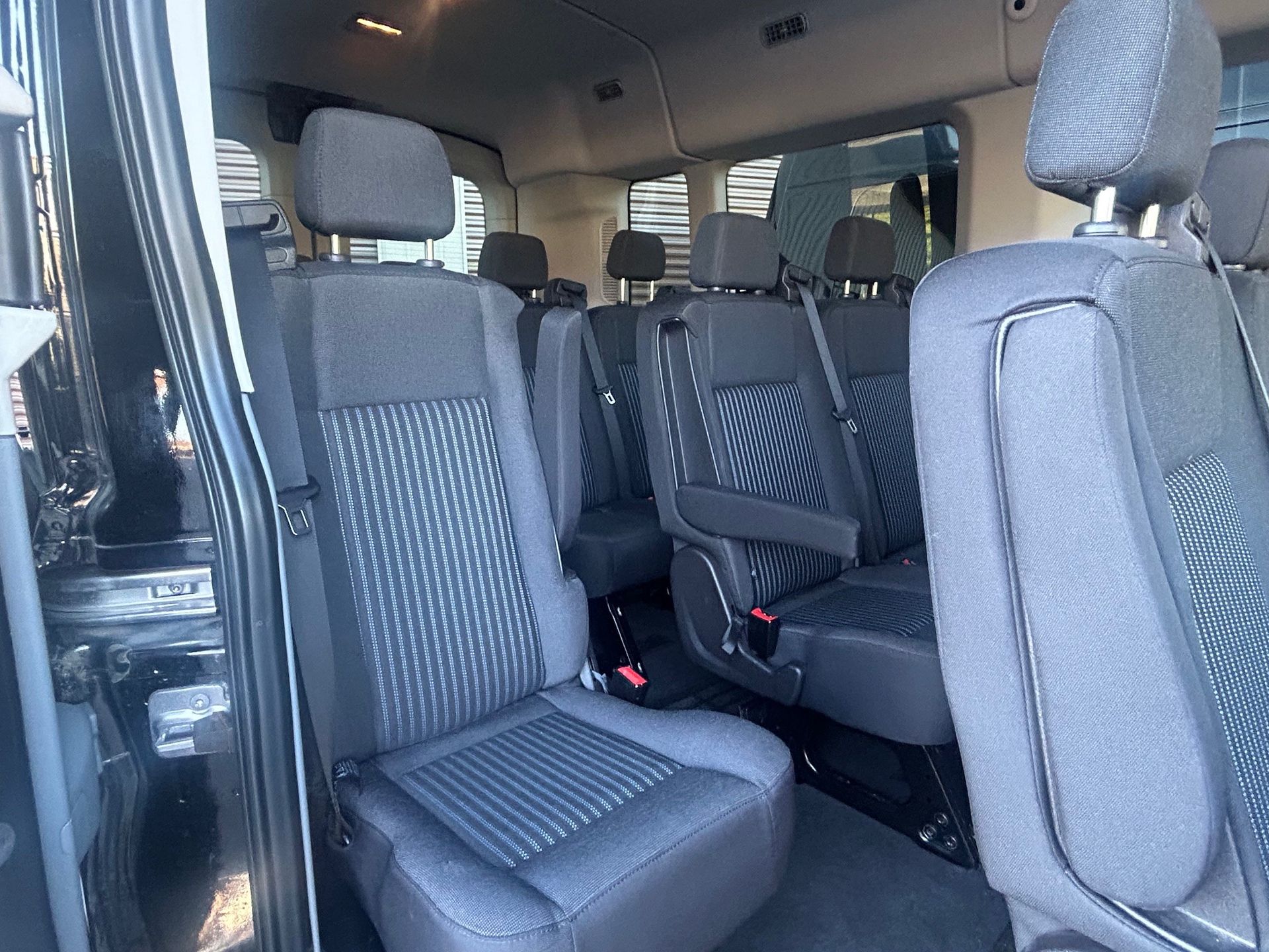 The inside of a van with a lot of seats.