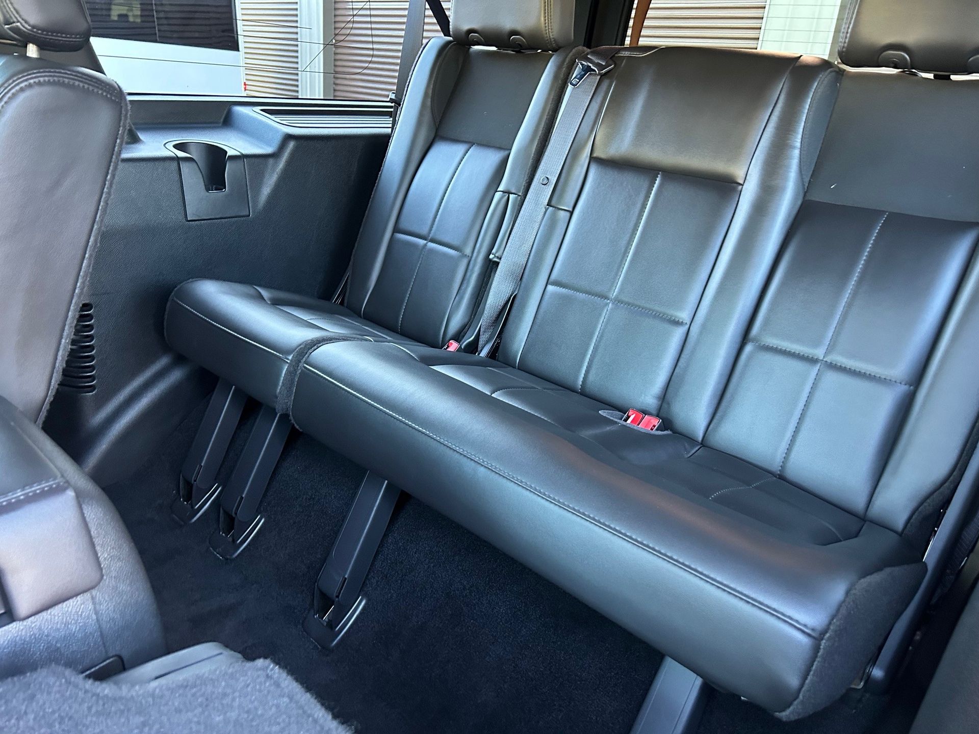 The rear seats of a jeep wrangler are black leather