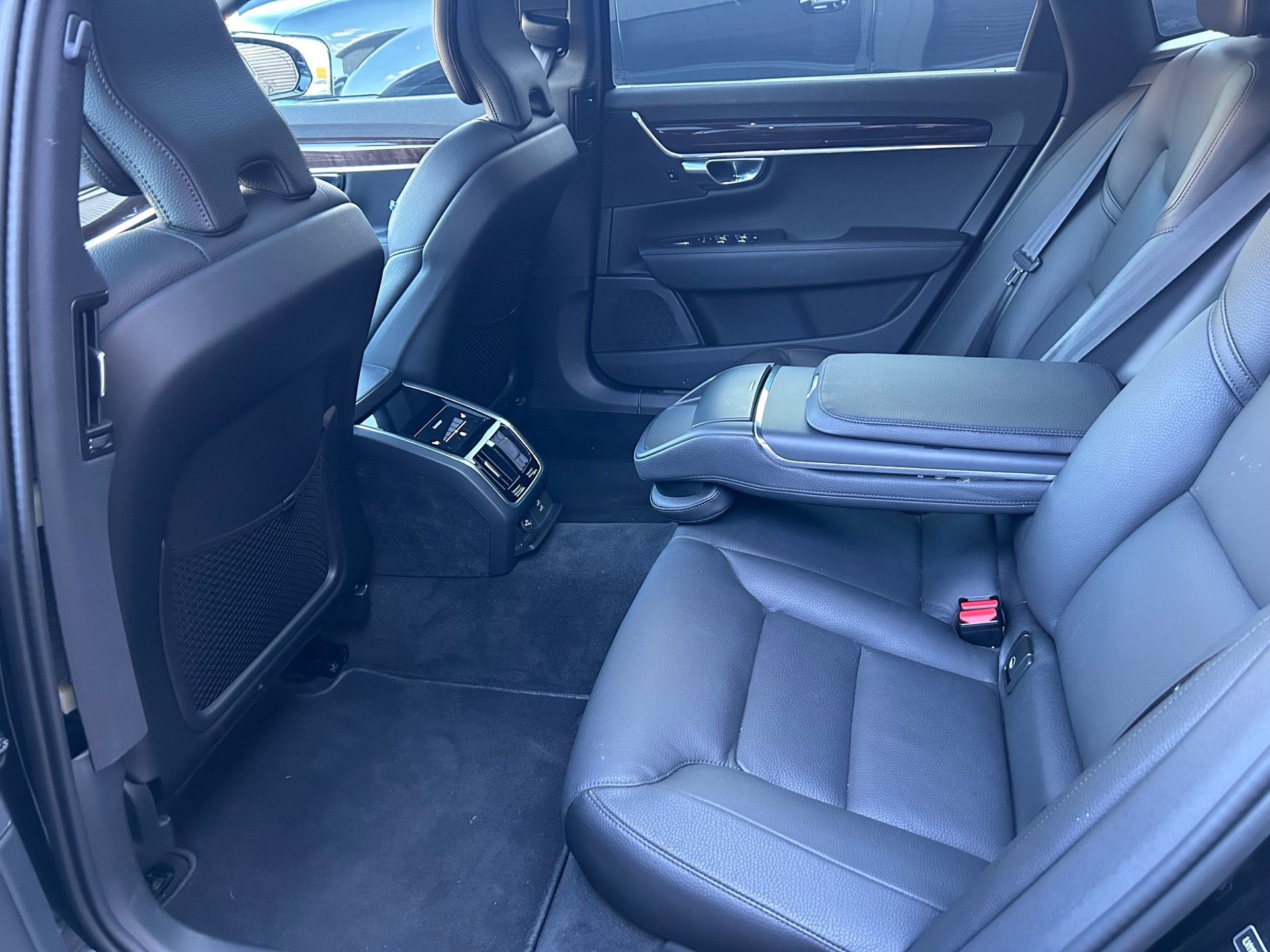 The rear seats of a black car are empty.