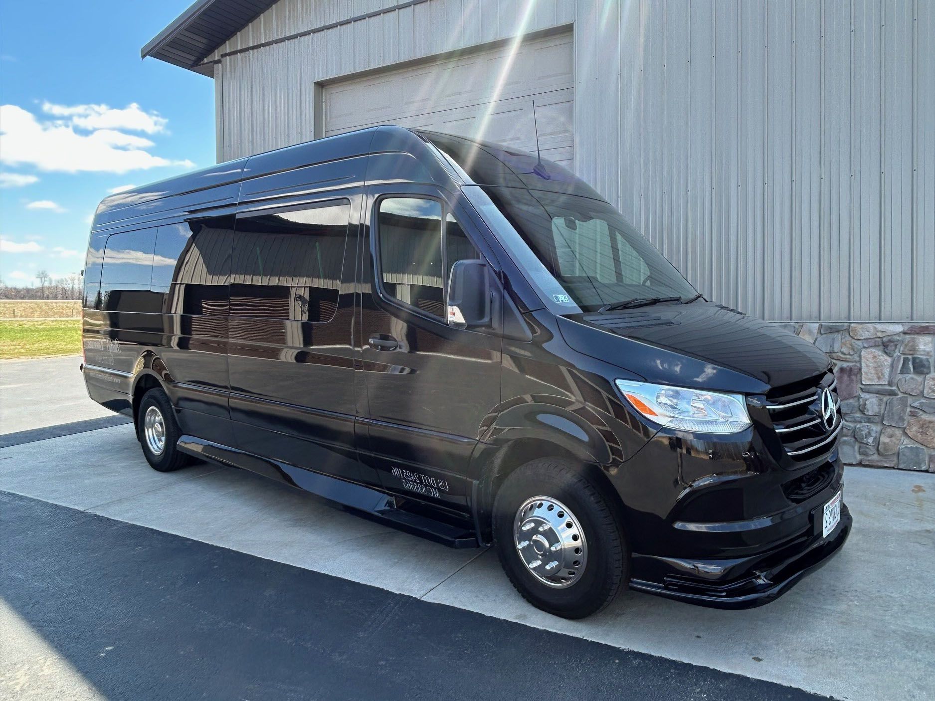A black van is parked in front of a building.