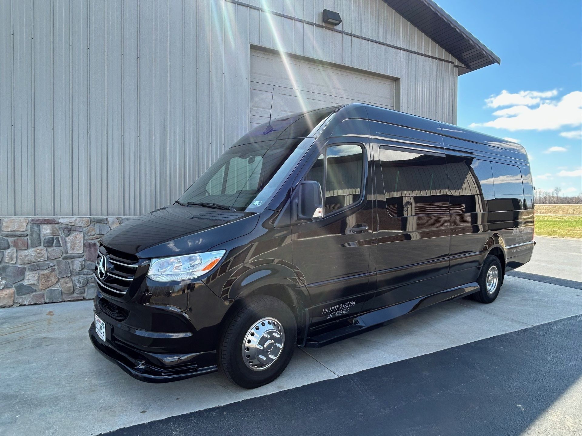 A black van is parked in front of a building.