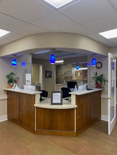 A waiting room with a lot of chairs and windows.