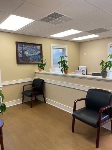 A dental office with a computer and a chair