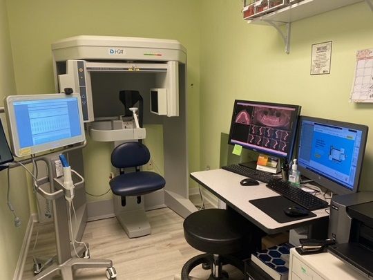 A dental office with a wooden reception desk and blue lights.