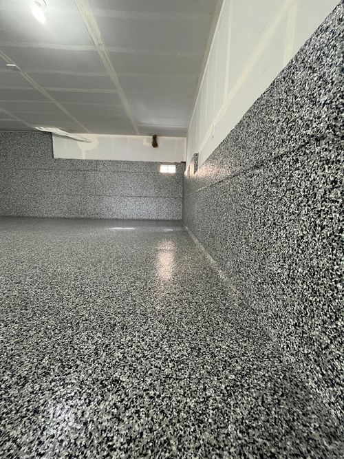An empty underground garage with white garage doors