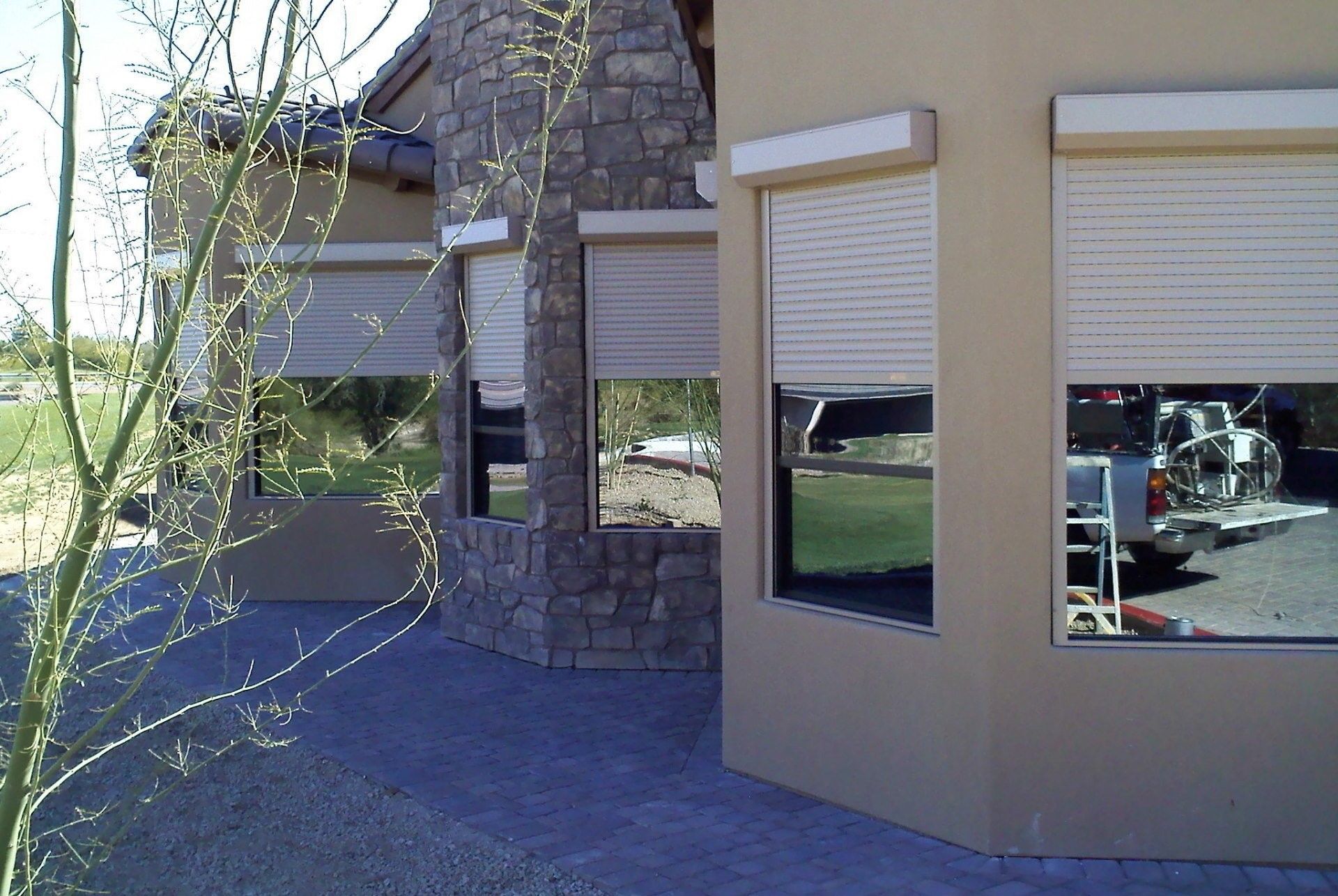 A house with a lot of windows and shutters on them