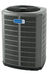 Gray outdoor air conditioning unit with a blue label on the front