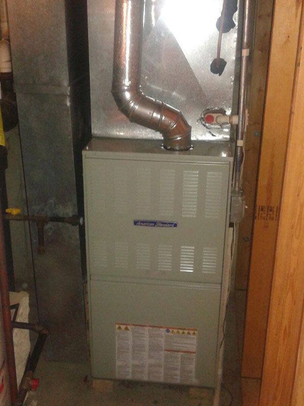 Basement furnace with copper ductwork and vents in a narrow utility space