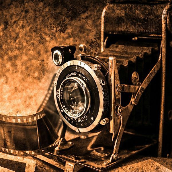 Vintage camera on a sepia-toned background, lit with warm, rustic lighting
