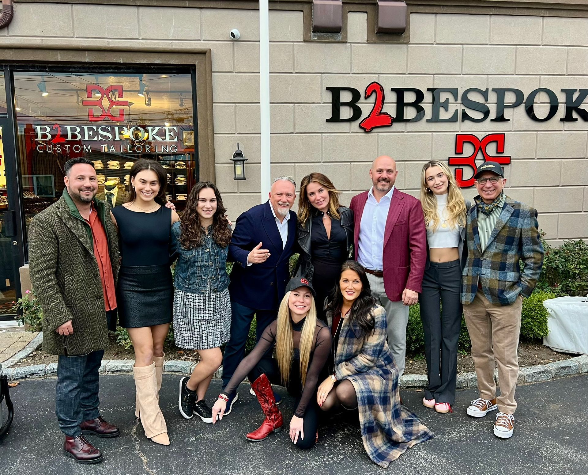 Group of people posing in front of a store called 