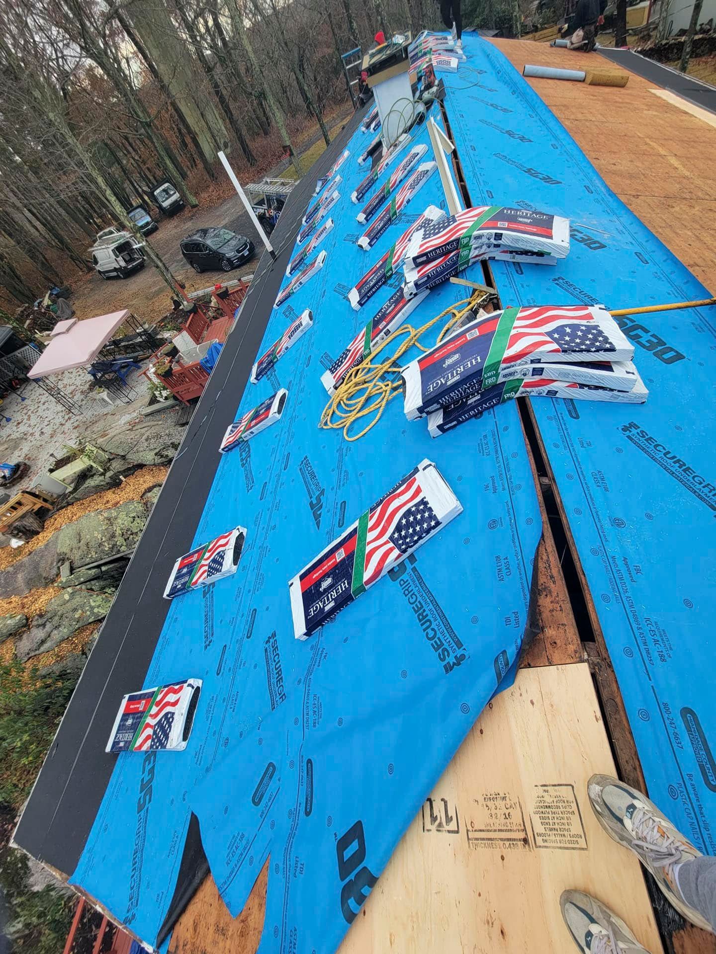 Blue tarp-covered roof with scattered campaign signs and debris after storm damage