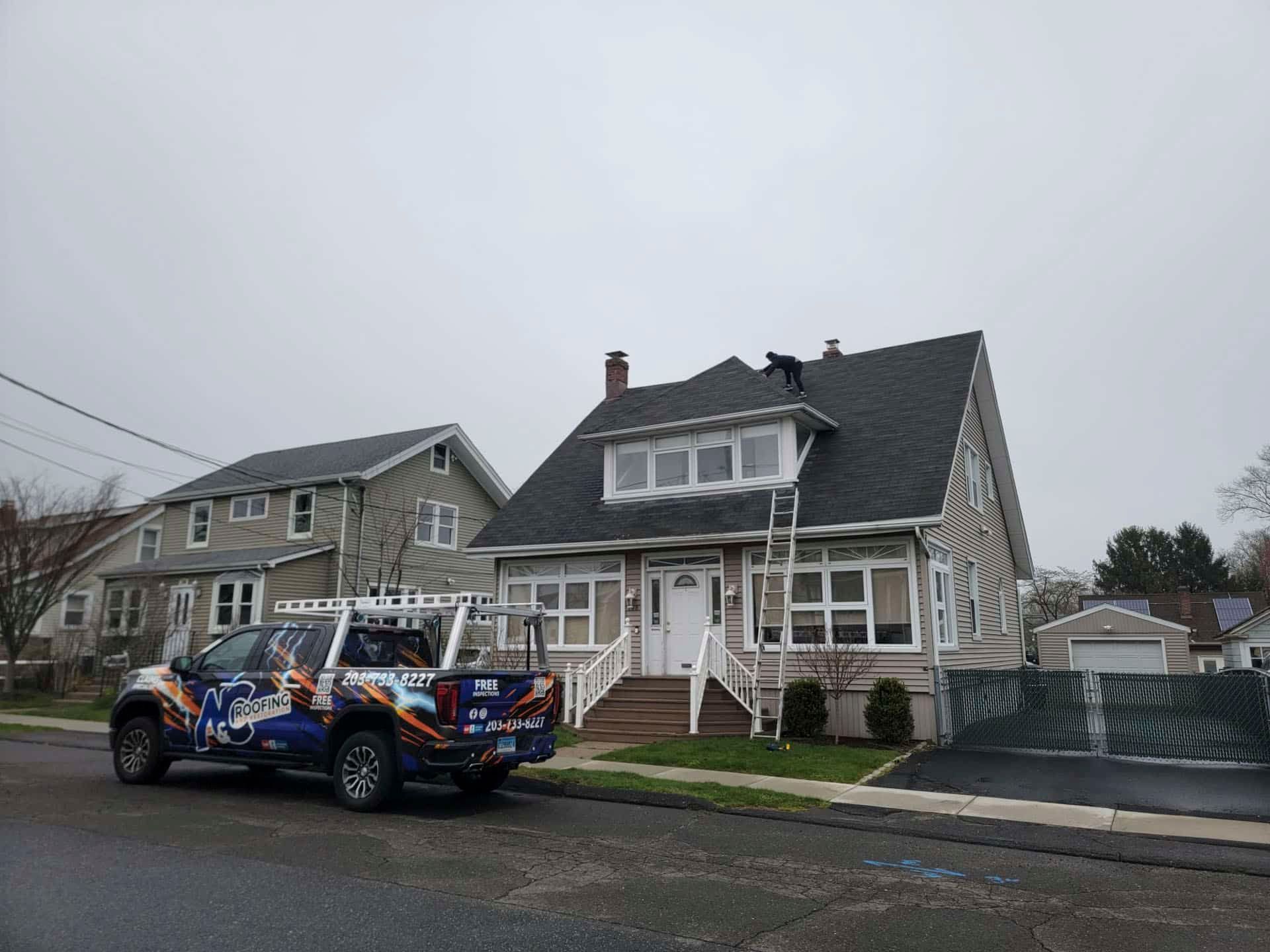 Off-road dune buggy parked beside a gray house on a cloudy suburban street