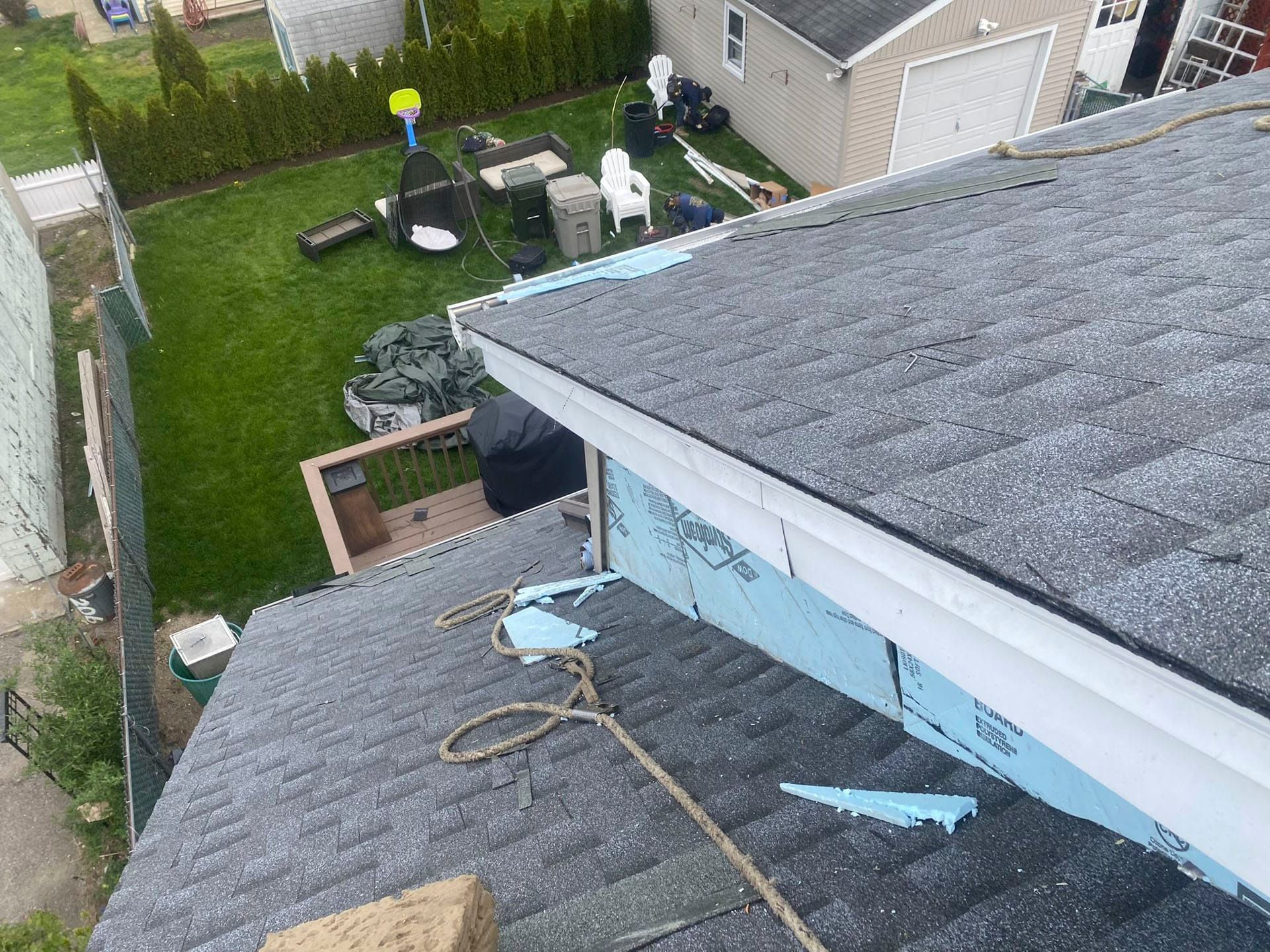 Roof view over a backyard with a lawn, patio furniture, and a shed/garage.