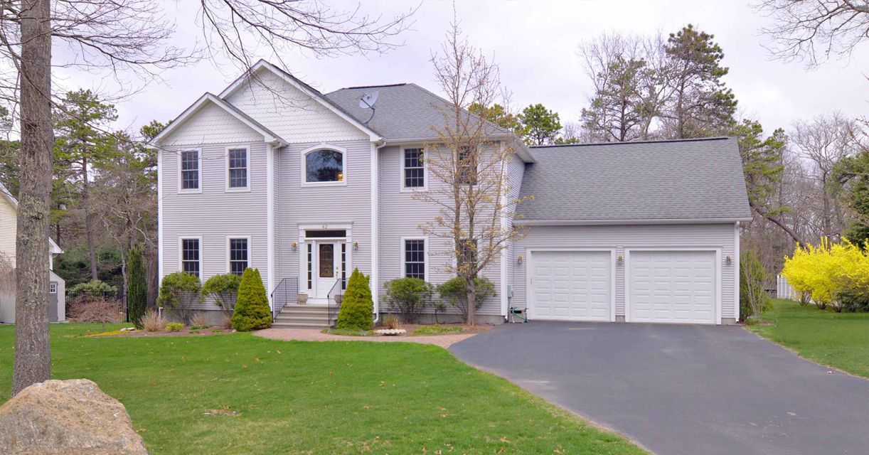 A large white house with a garage and a driveway