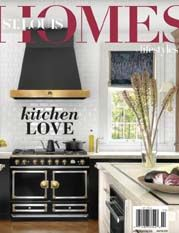 St. Louis Homes & Lifestyles magazine cover featuring a bright, modern kitchen with a black stove and gold accents