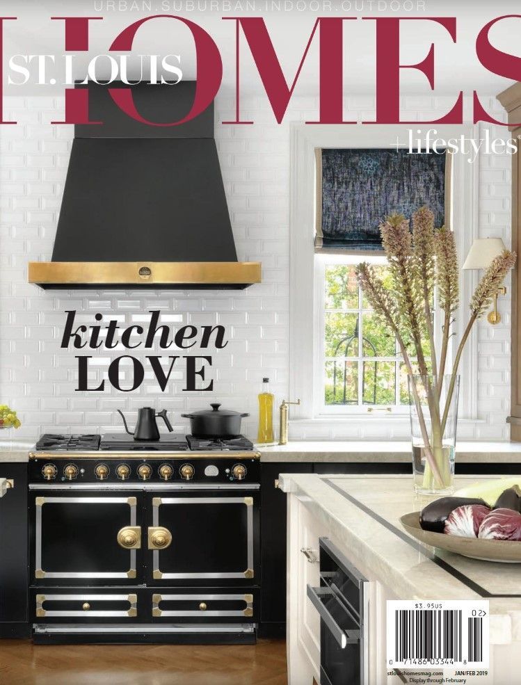 A kitchen magazine cover titled kitchen LOVE featuring a black range stove with gold accents against a white tile wall.