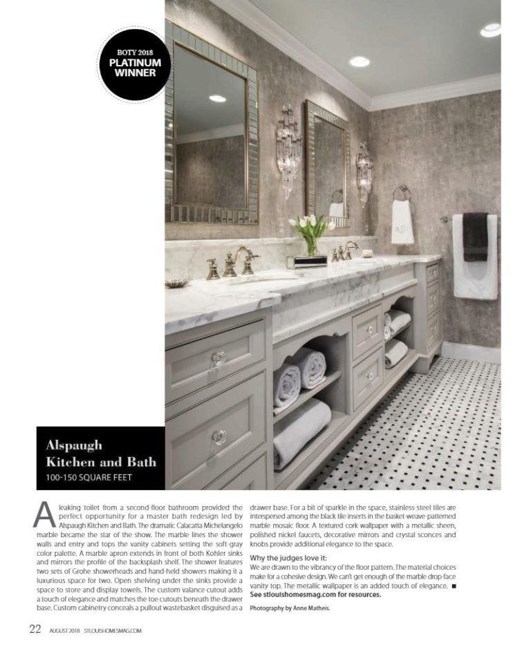 A luxurious bathroom with a double marble vanity, grey cabinets, open shelving for towels, and patterned floor tiles.