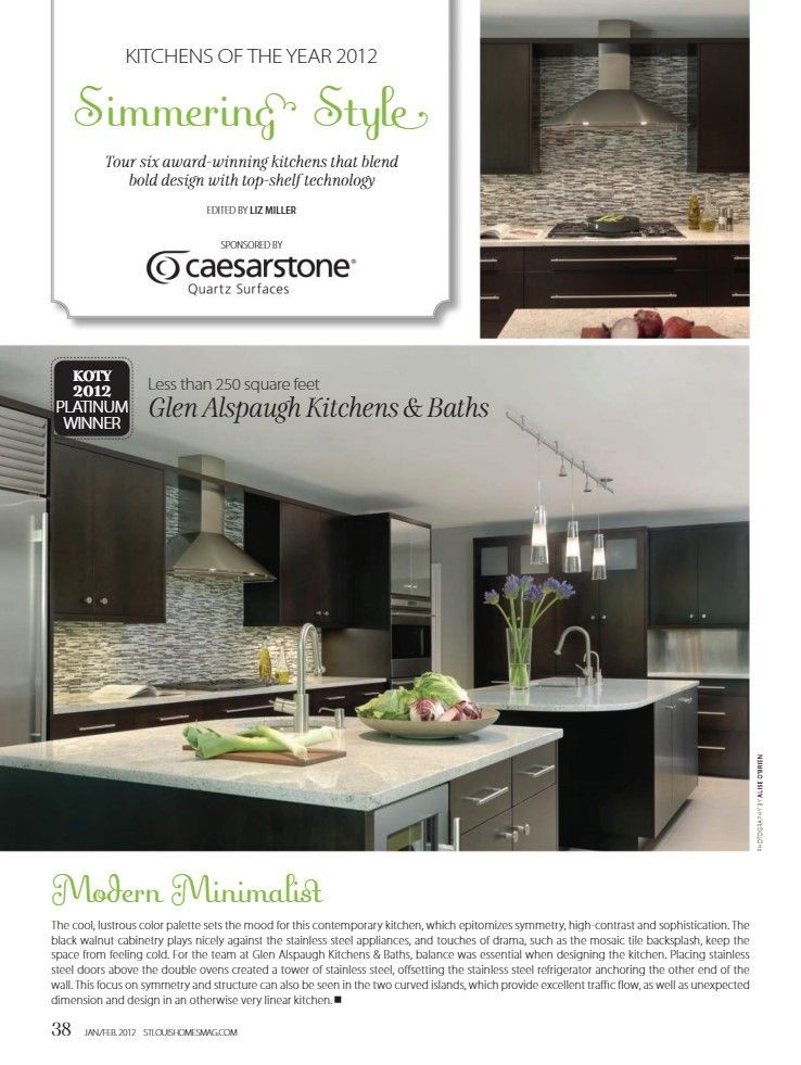 A magazine spread showcasing a sleek modern kitchen with dark cabinetry, a light stone island, and a mosaic backsplash.