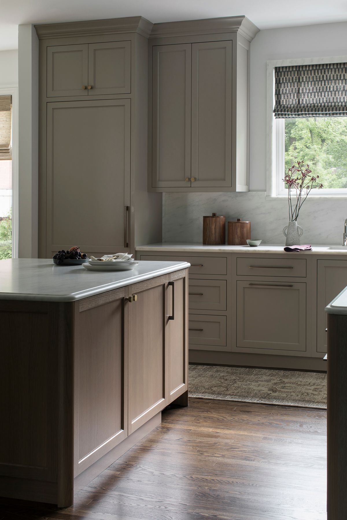 Modern kitchen with taupe cabinets, wooden island, and a window above the sink