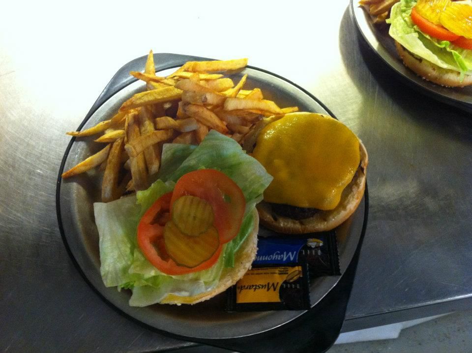 A plate of food with a hamburger and french fries