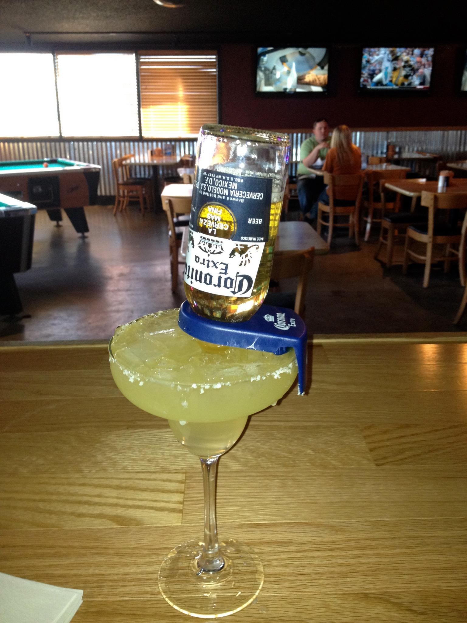 A margarita with a corona beer on top of it