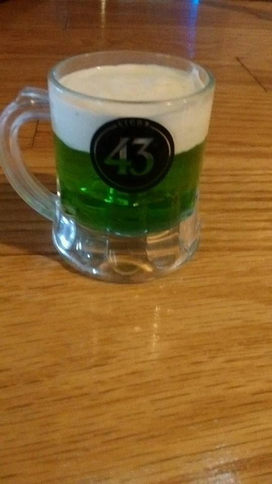 A mug with green liquid and the number 43 on it