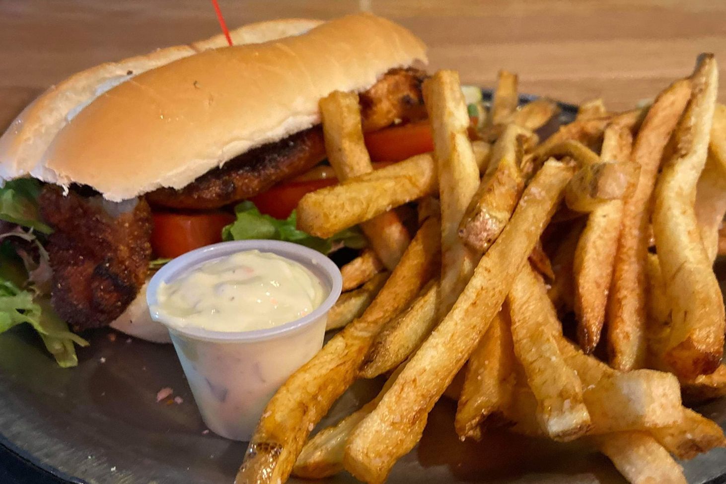 There is a sandwich and french fries on a plate.