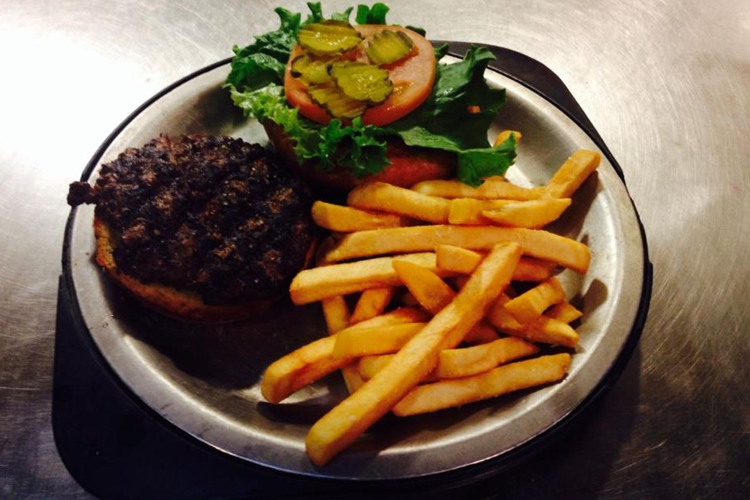 A plate with a hamburger and french fries on it