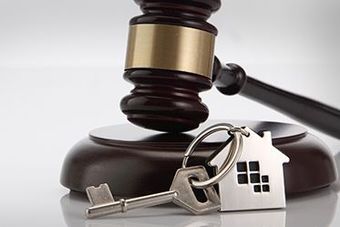 A wooden stamp is sitting on top of a piece of paper next to a pen and a judge 's gavel.