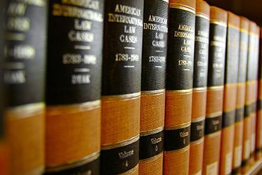 A row of law books are lined up on a shelf.
