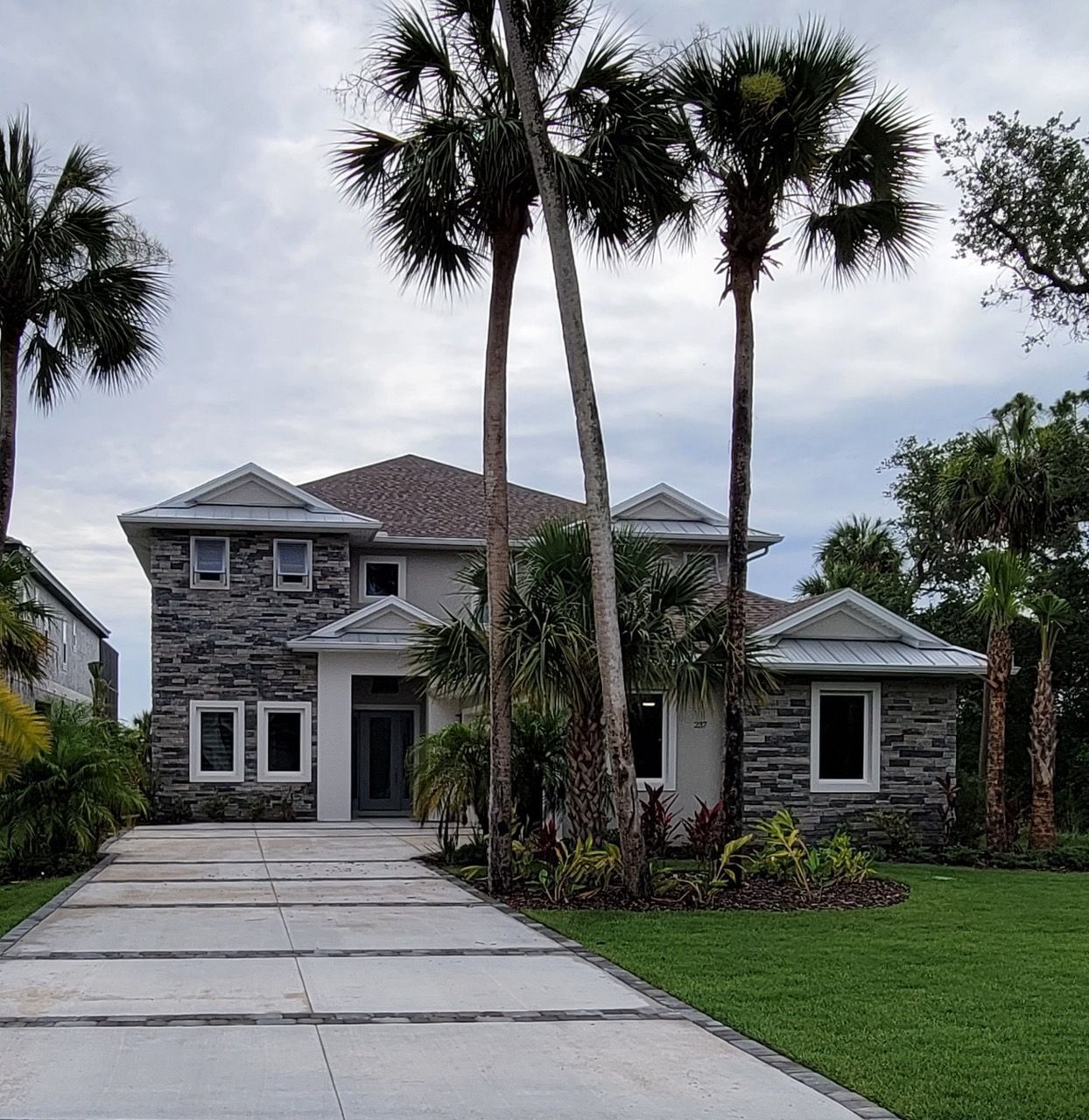 A large house with palm trees in front of it