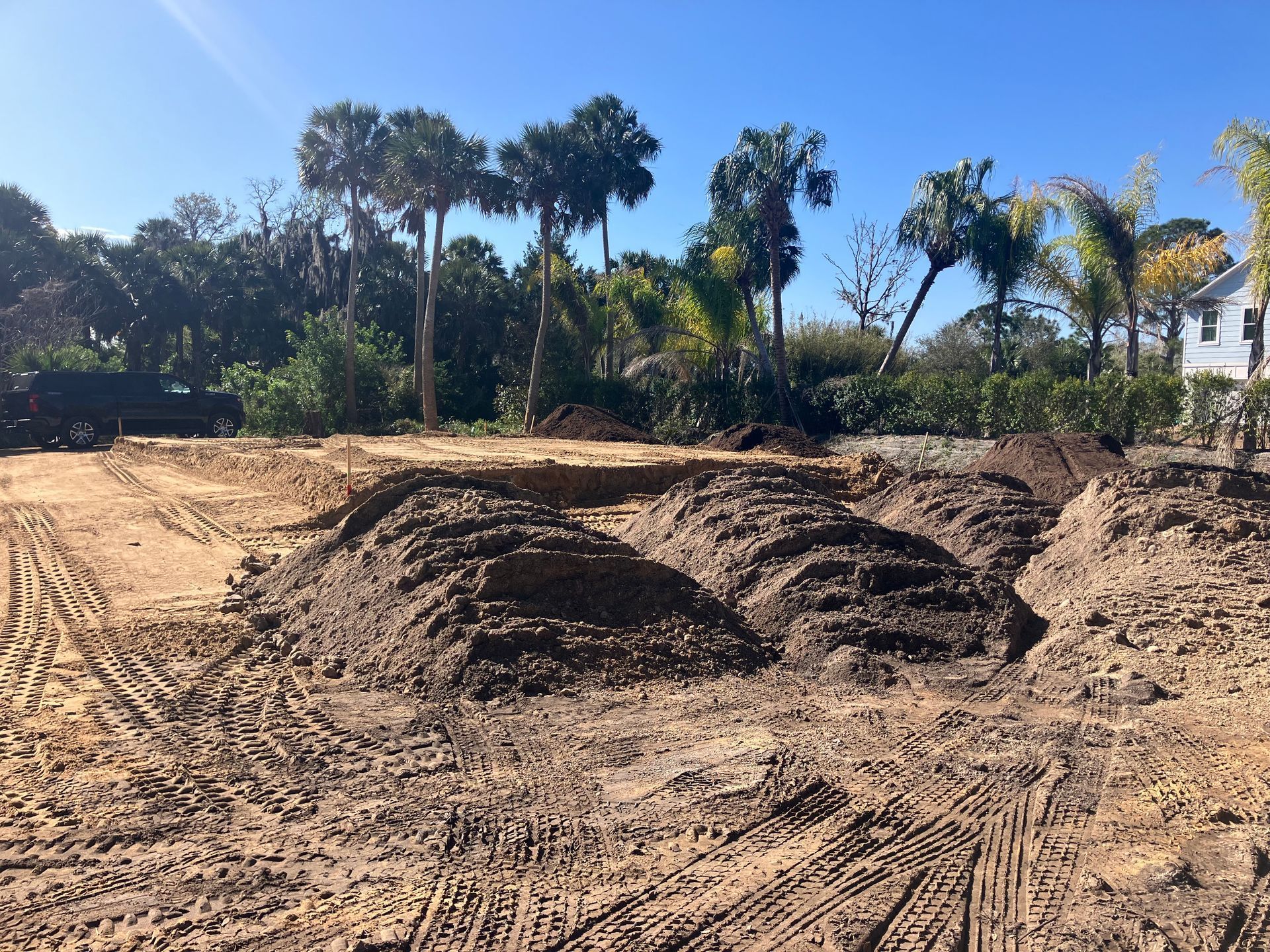 A pile of dirt is in the middle of a dirt road