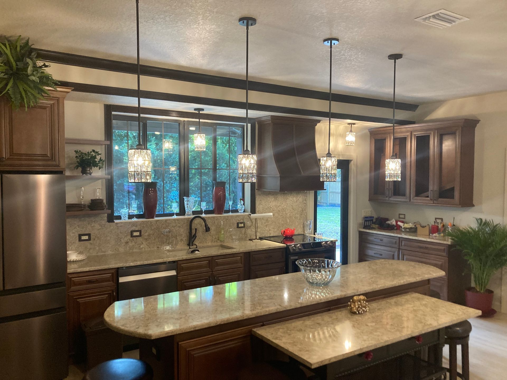A kitchen with a large island and stainless steel appliances