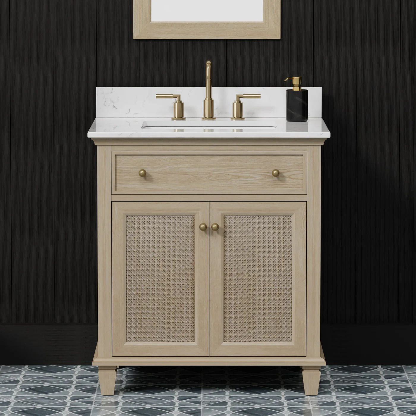 Beige vanity cabinet with white countertop, gold faucet, and woven door fronts against a dark wall