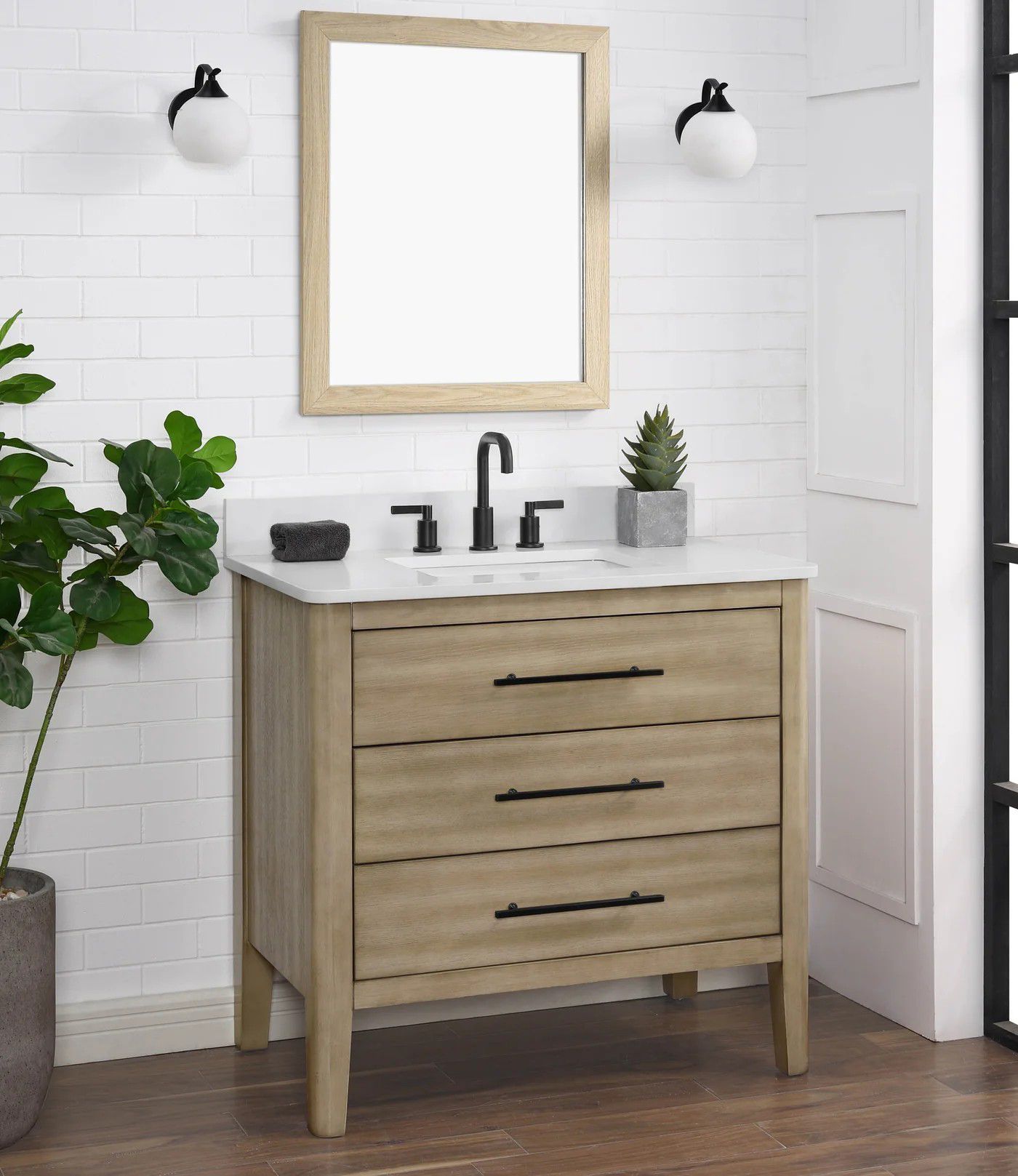 Modern bathroom vanity with wood cabinet, white sink, mirror, and wall sconces in a bright tiled room