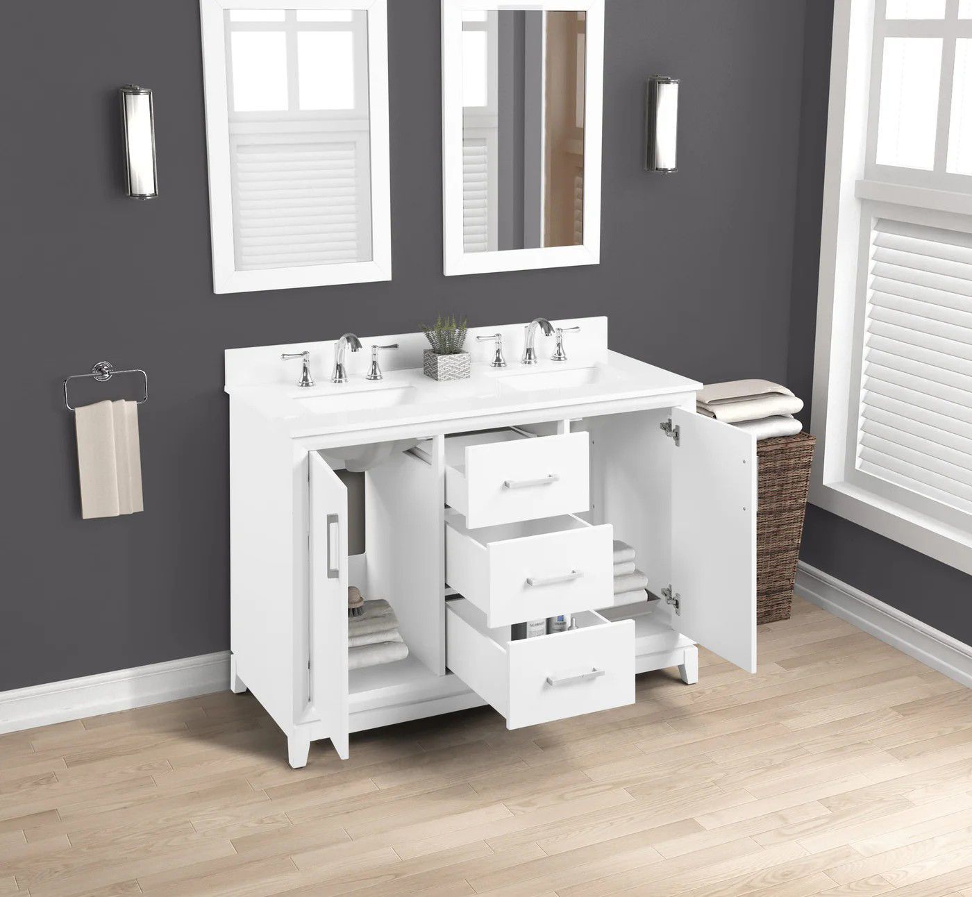White bathroom vanity with mirror, drawers, open cabinet, and towel rack against a gray wall and wood floor