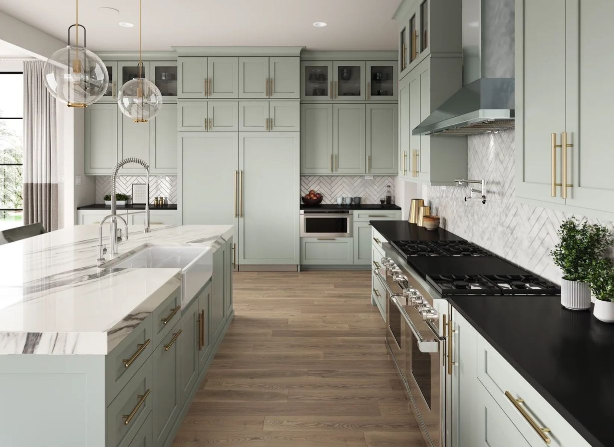 Modern bright kitchen with white cabinets, black countertops, wood floors, and a large island with pendant lights