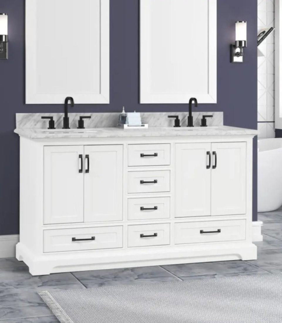 White double-sink bathroom vanity with black faucets, drawers, and cabinets against a purple wall
